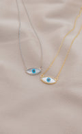Zamari two necklaces with blue evil eye pendants on gold and silver chains from online dainty jewelry boutique