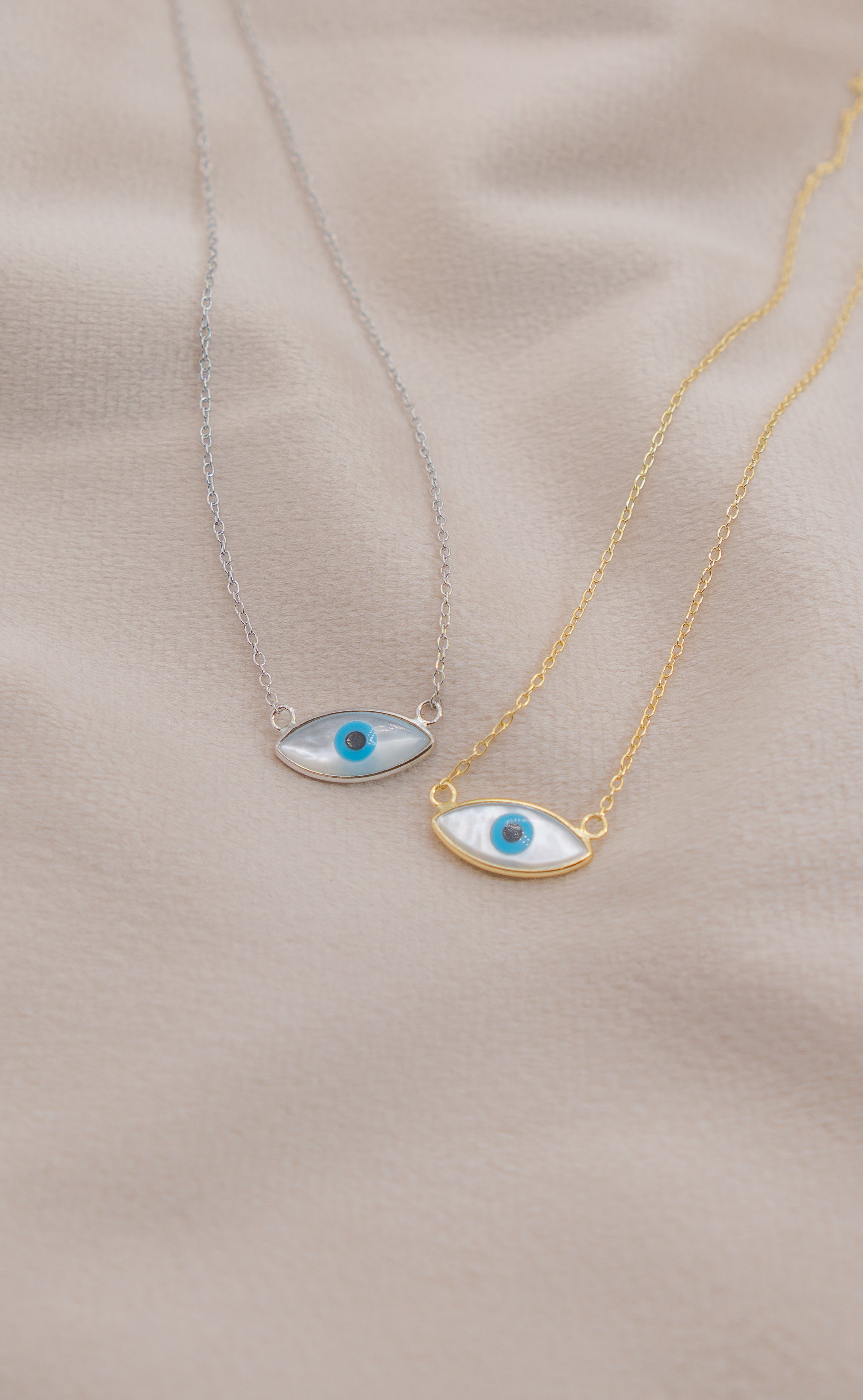 Zamari two necklaces with blue evil eye pendants on gold and silver chains from online dainty jewelry boutique