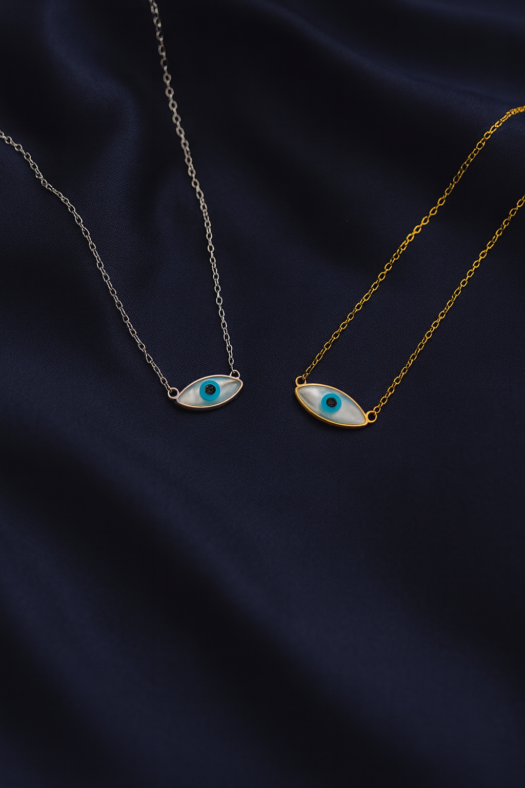 Two Zamari eye-shaped necklaces on delicate chains from an online dainty jewelry boutique