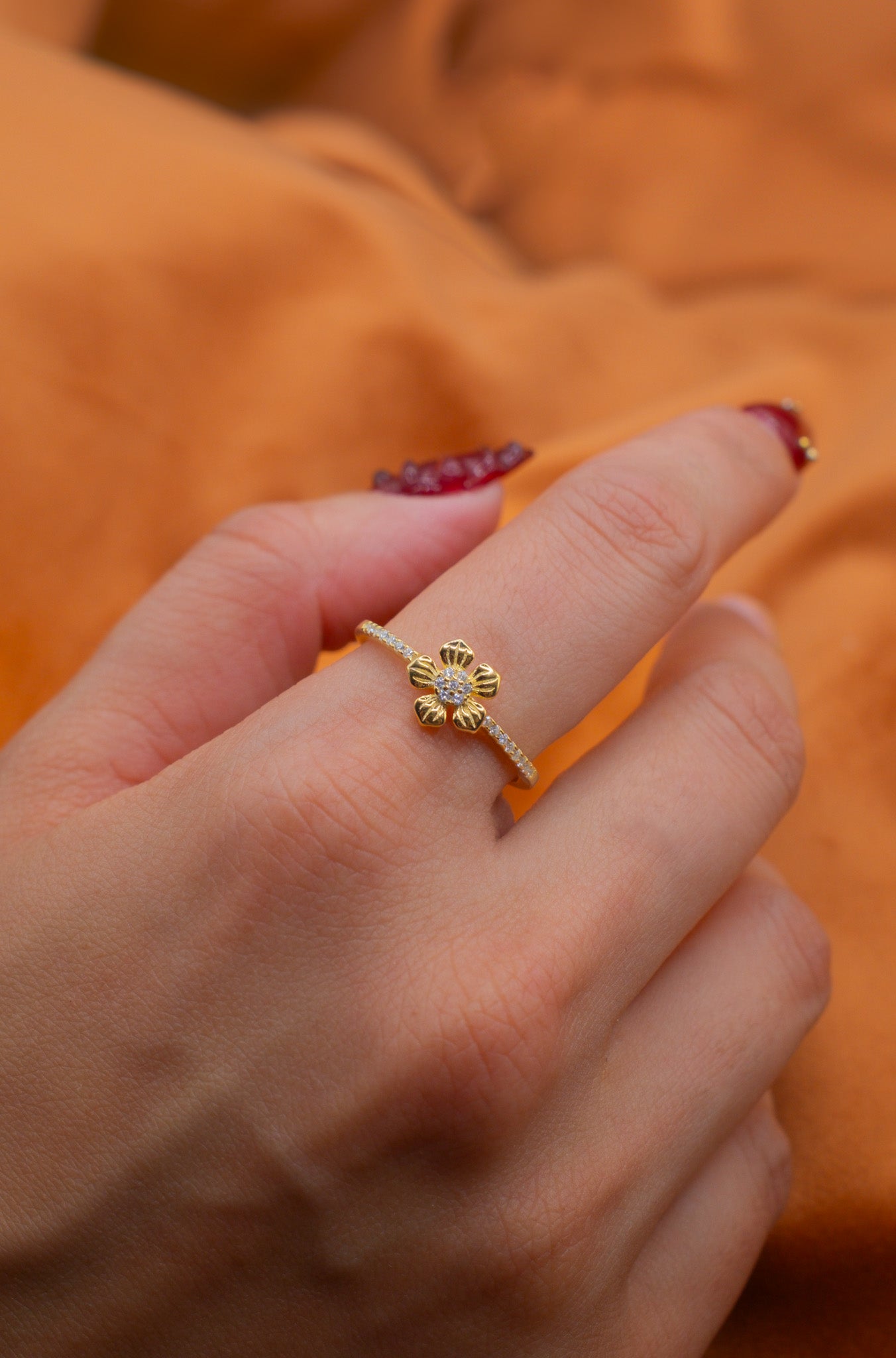 Zamari gold flower ring worn on hand from online dainty jewelry boutique collection