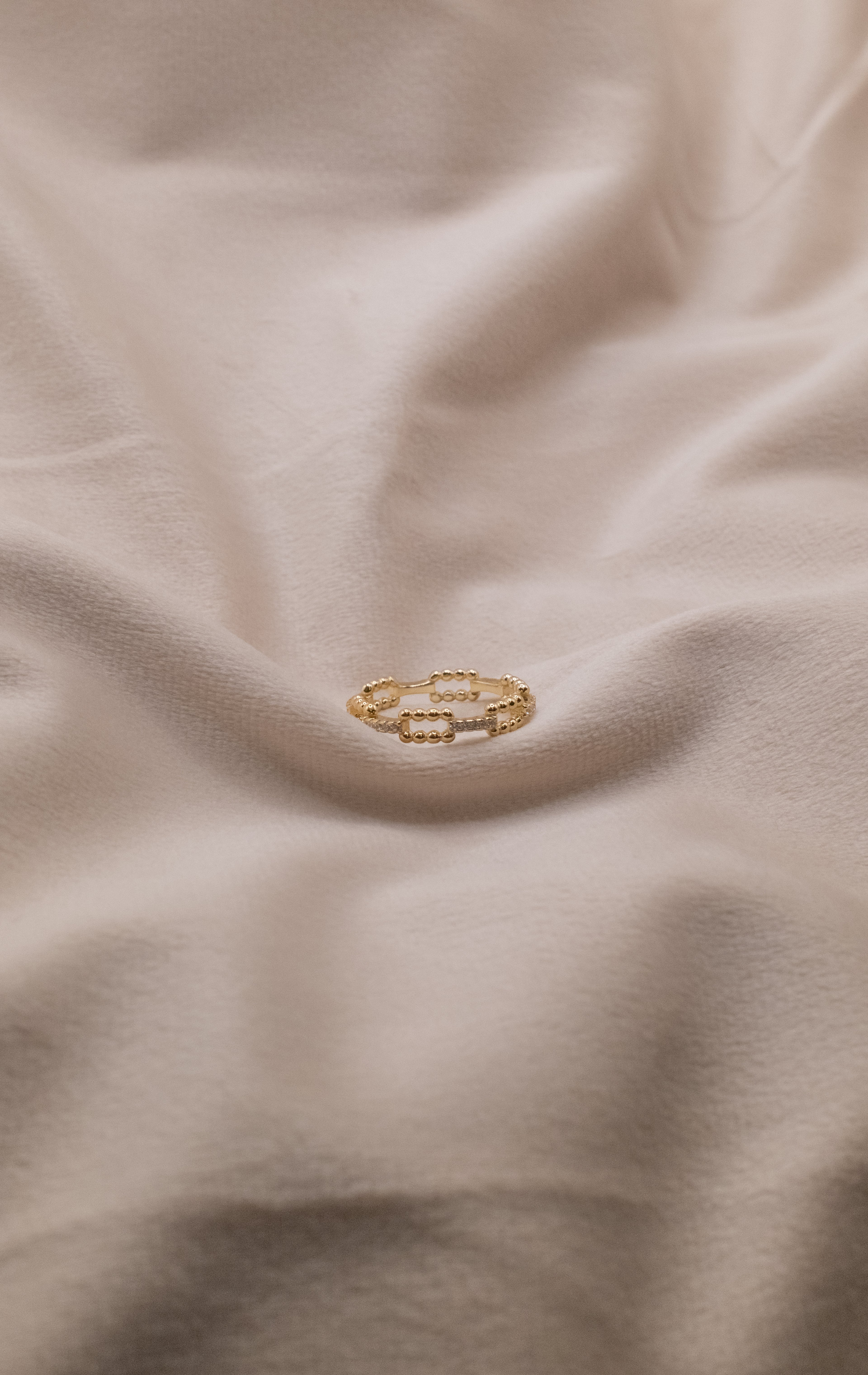 Zamari gold ring on soft fabric from online dainty jewelry boutique collection