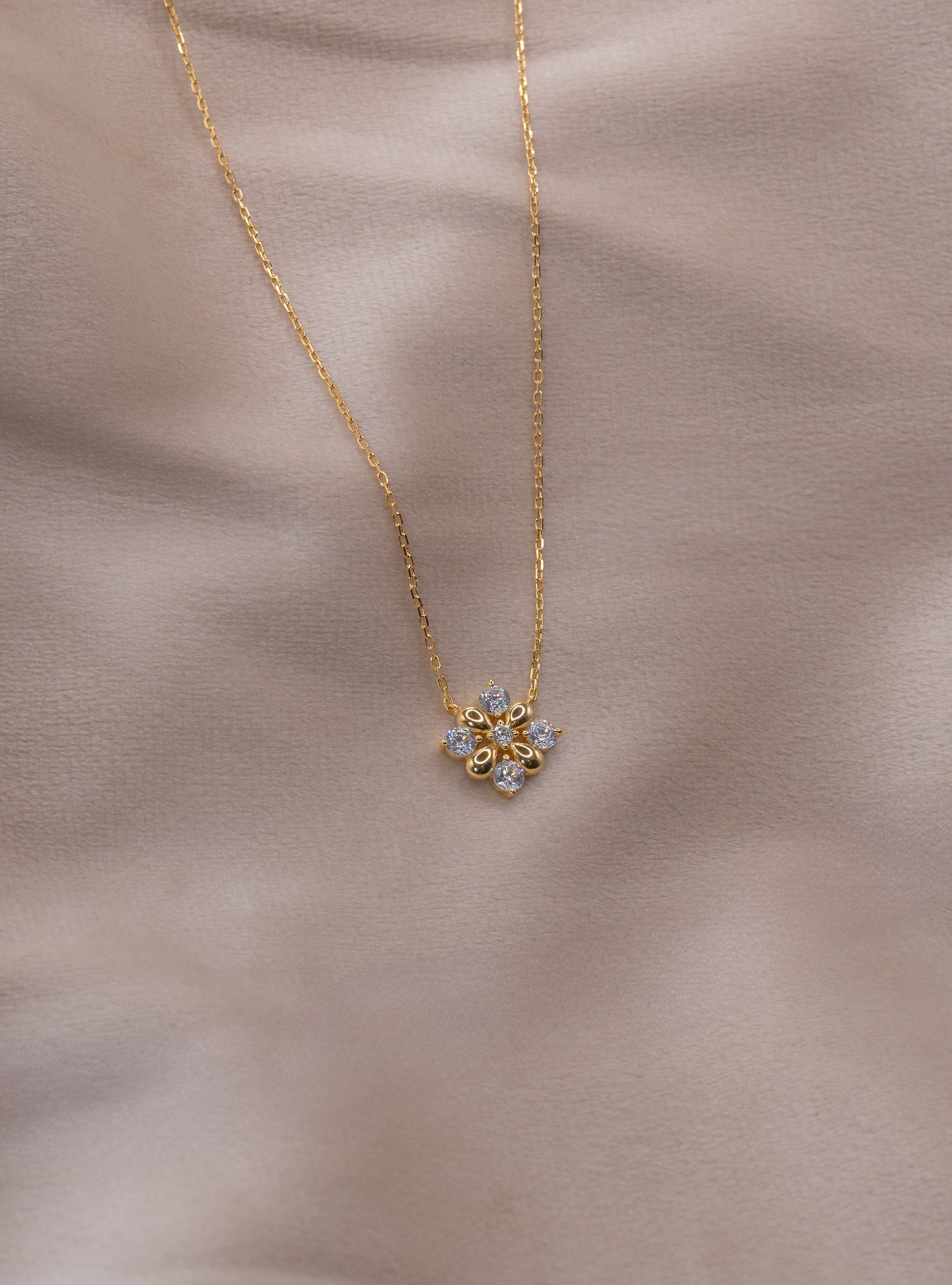 Zamari gold necklace with floral pendant featuring clear stones from an online dainty jewelry boutique