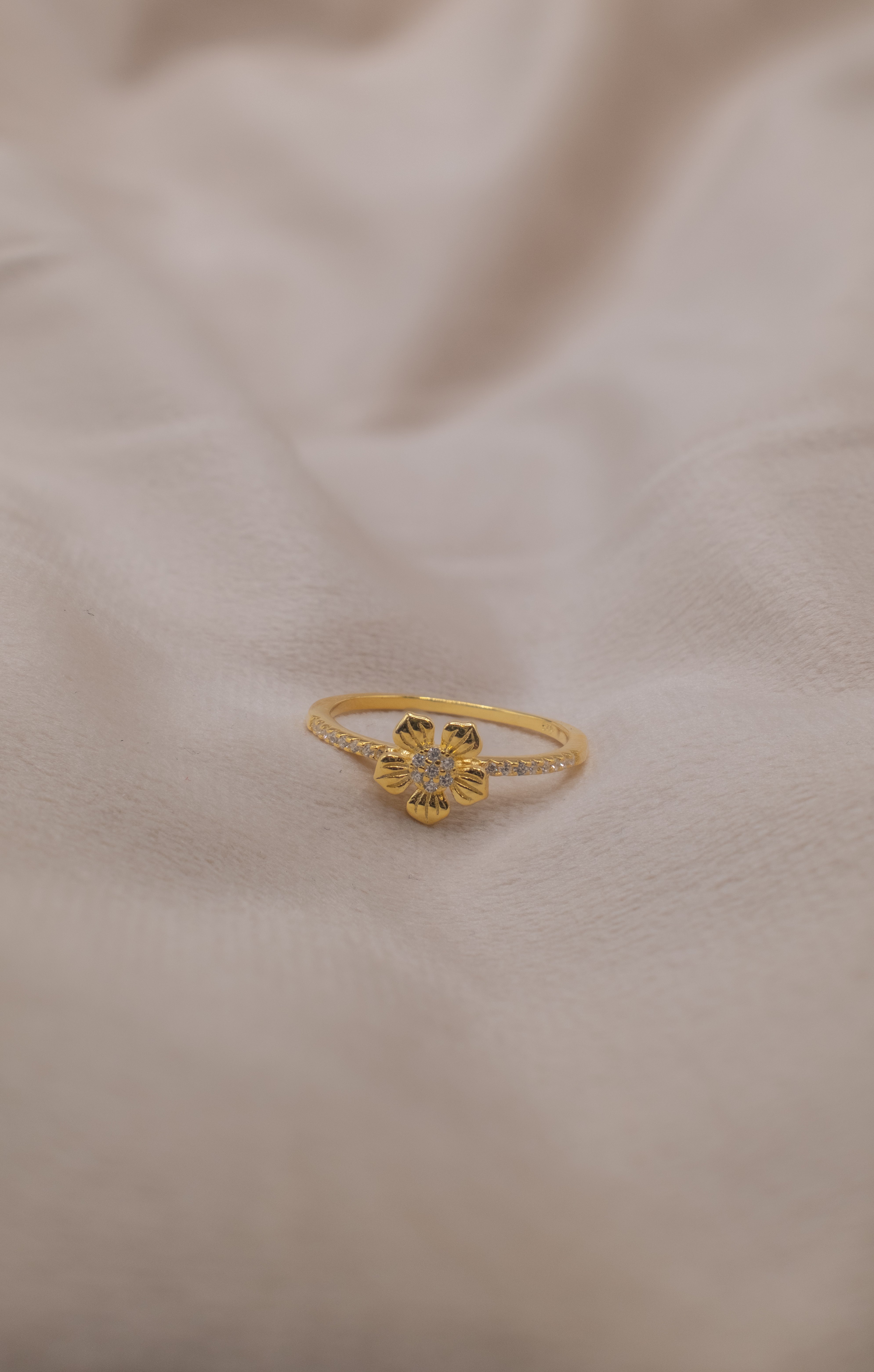 Zamari gold flower ring with small stones from an online dainty jewelry boutique