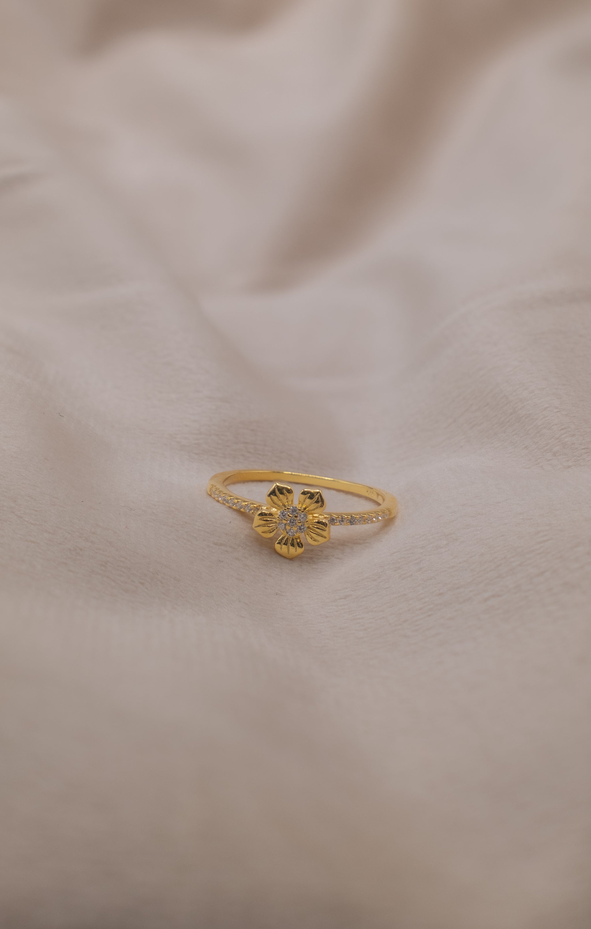 Zamari gold flower ring with small stones from an online dainty jewelry boutique