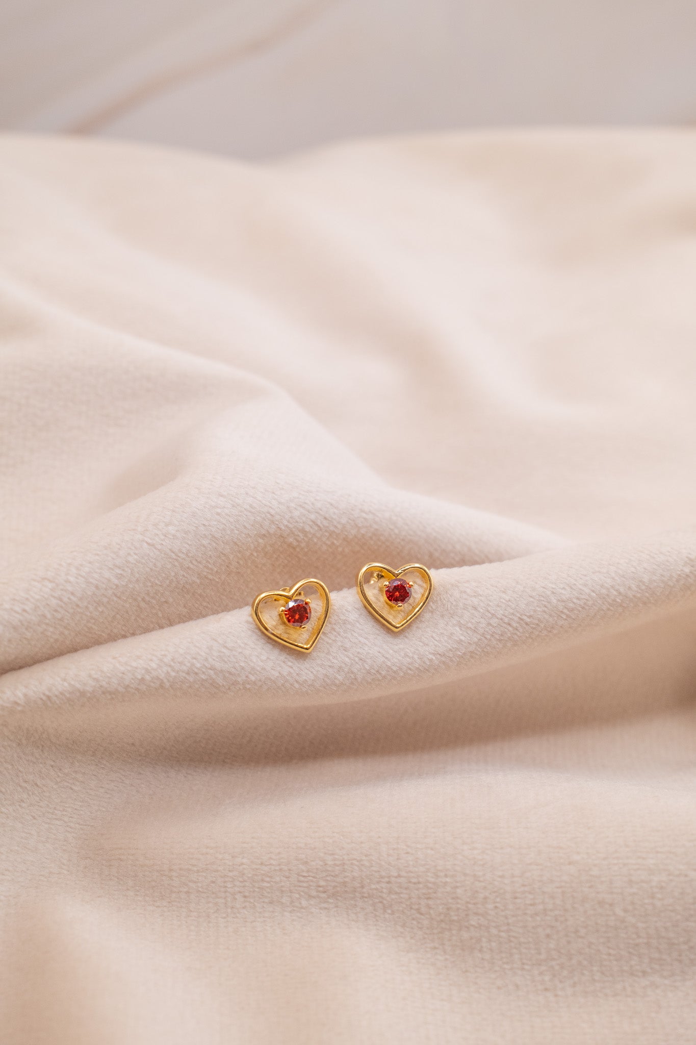 Zamari gold heart-shaped earrings with red stones from online dainty jewelry boutique
