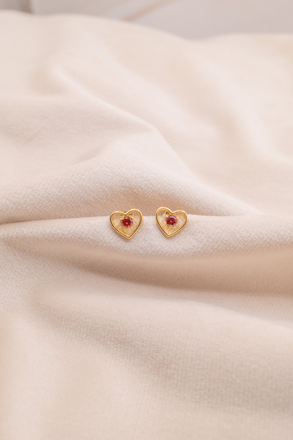 Zamari gold heart earrings with red center gemstone from online dainty jewelry boutique