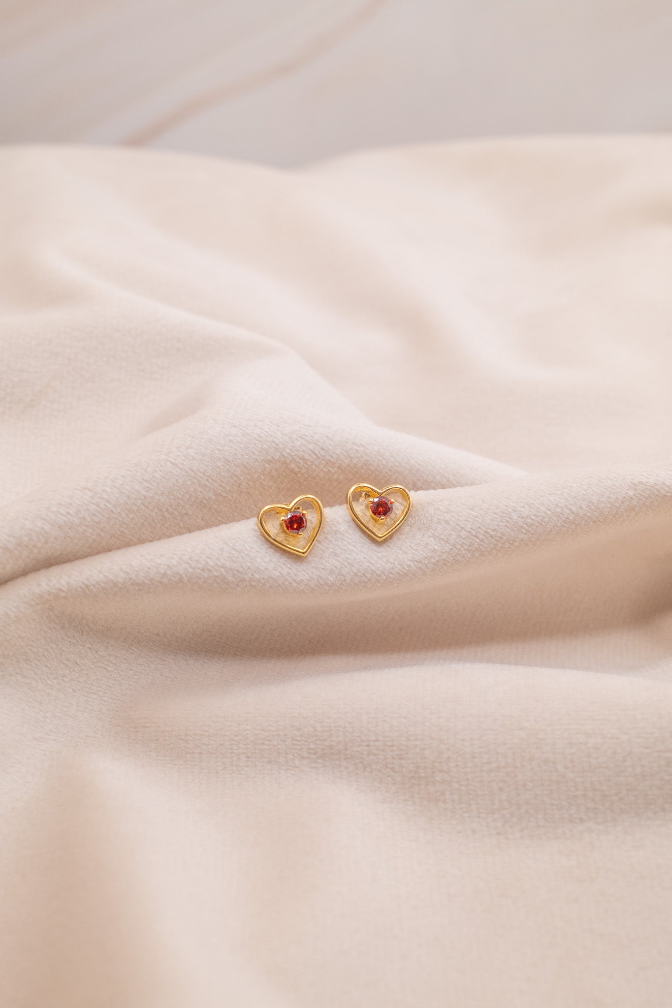 Zamari gold heart-shaped earrings with red stones from online dainty jewelry boutique