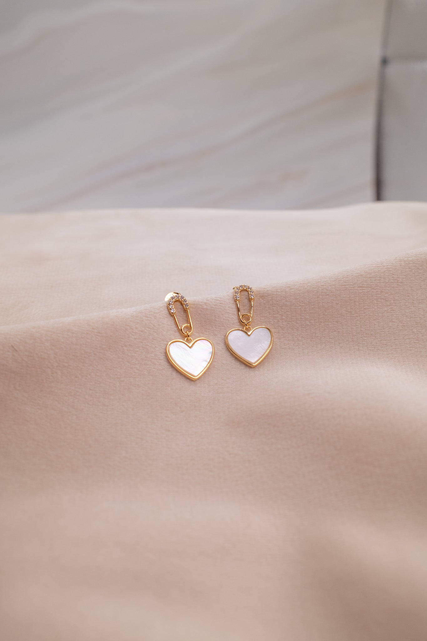 Gold heart-shaped earrings with white enamel from Zamari online dainty jewelry boutique