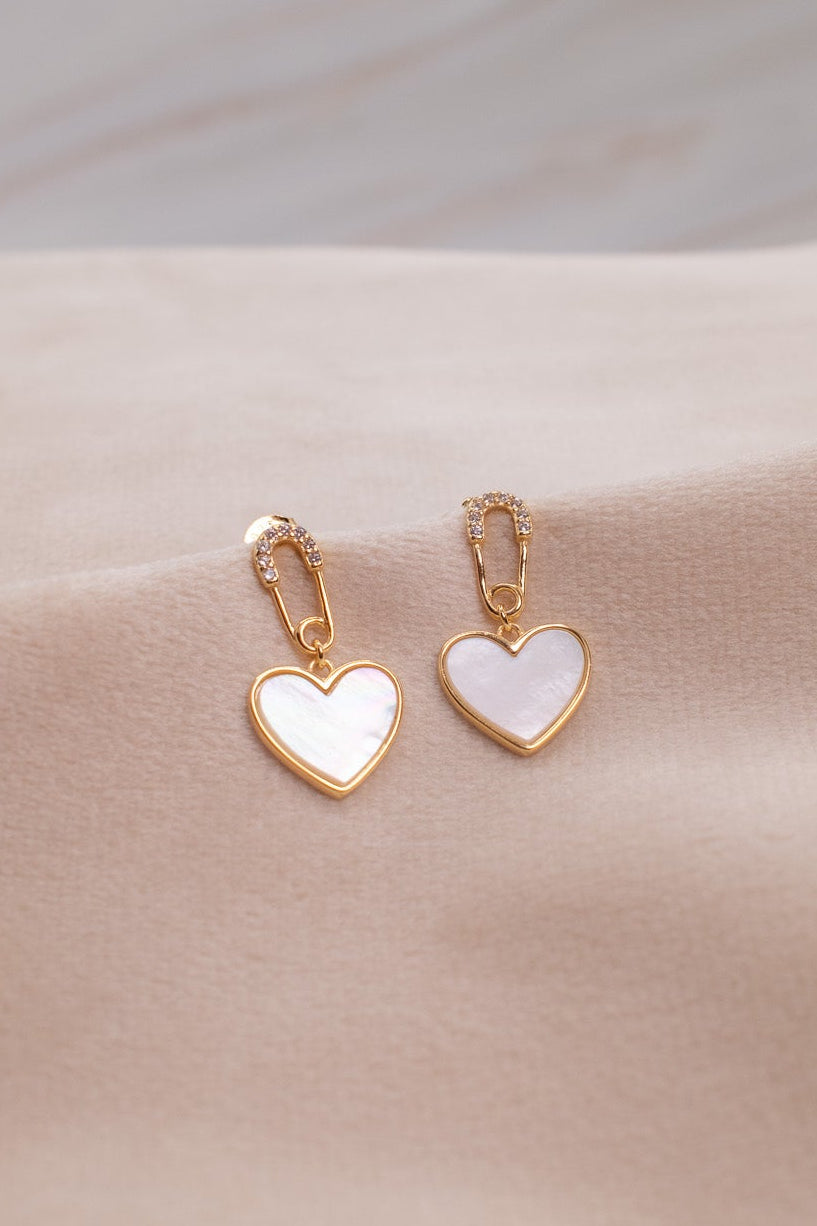 Gold heart-shaped earrings with white enamel from Zamari online dainty jewelry boutique