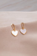 Gold heart-shaped earrings with white enamel from Zamari online dainty jewelry boutique