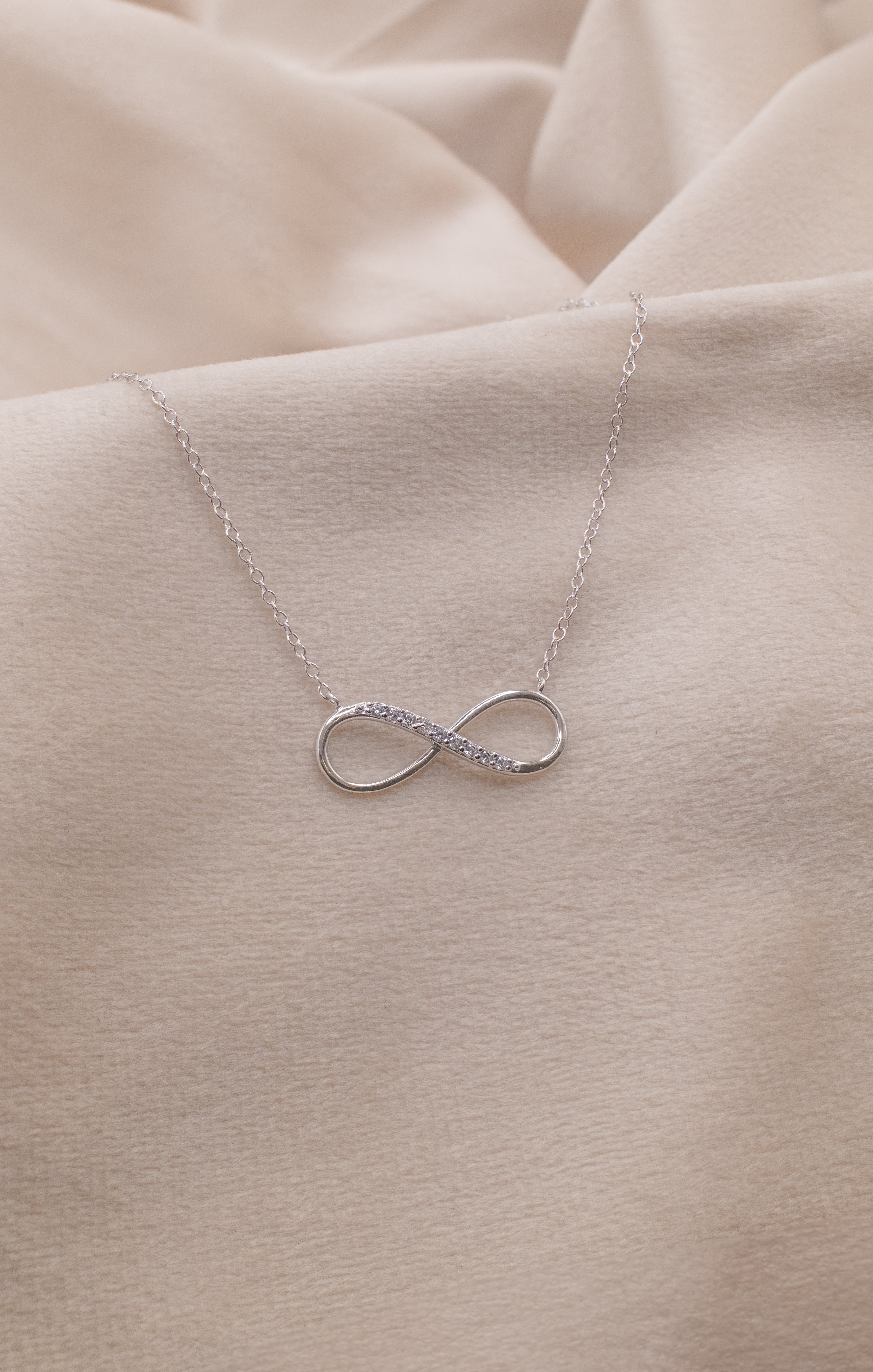 Silver infinity necklace with delicate chain from Zamari online dainty jewelry boutique