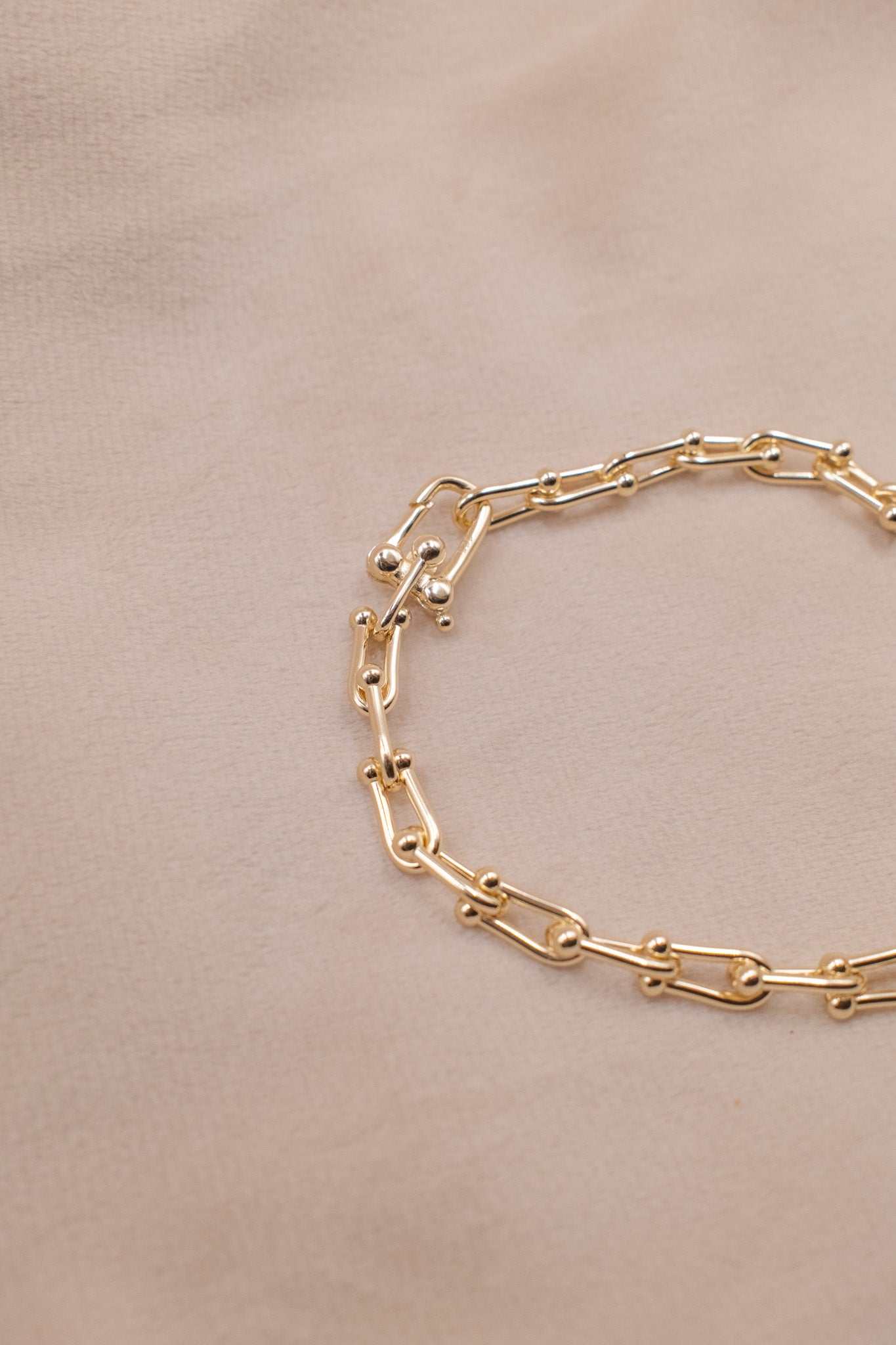 Zamari gold chain bracelet on beige background Sterling Silver Jewelry accessory