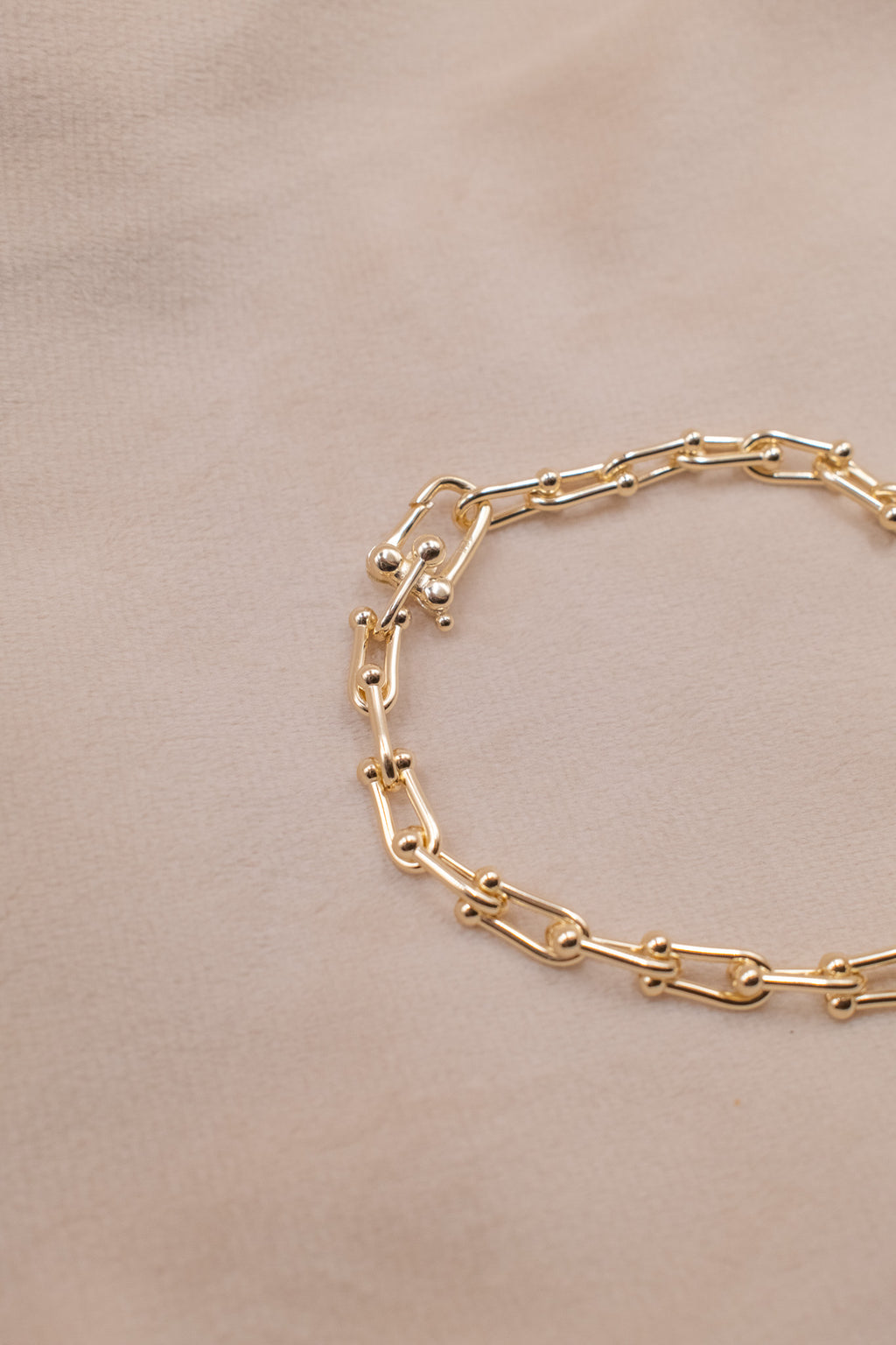 Zamari gold chain bracelet on beige background Sterling Silver Jewelry accessory