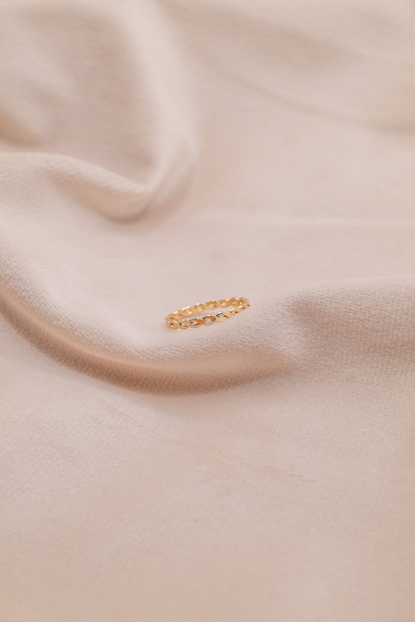Zamari delicate gold chain ring on soft beige fabric featuring sterling silver jewelry design