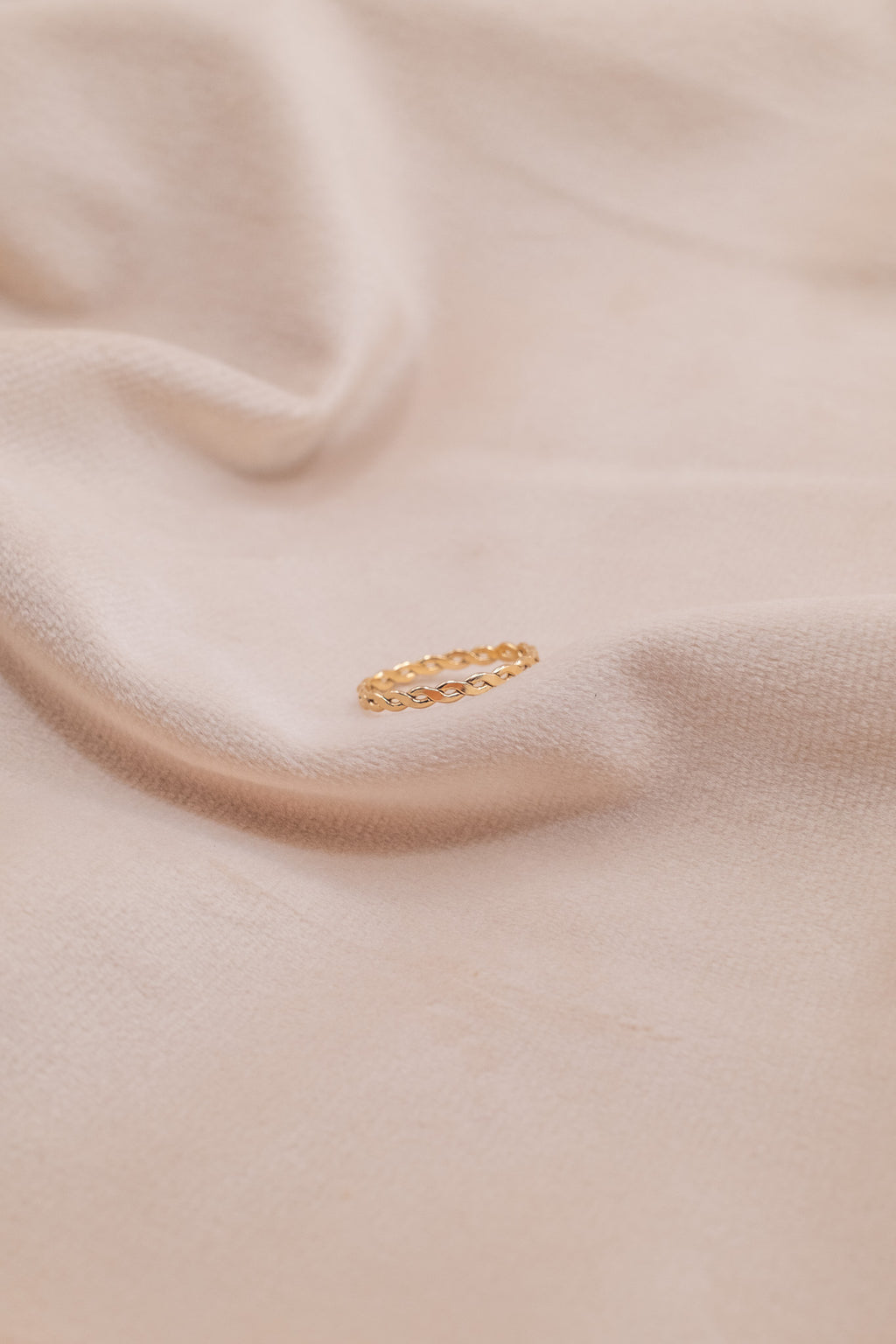 Zamari delicate gold chain ring on soft beige fabric featuring sterling silver jewelry design